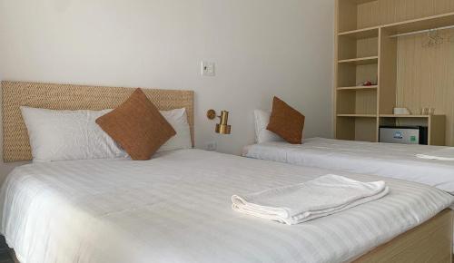 Postel nebo postele na pokoji v ubytování Flora Hotel - Phan Rí Cửa