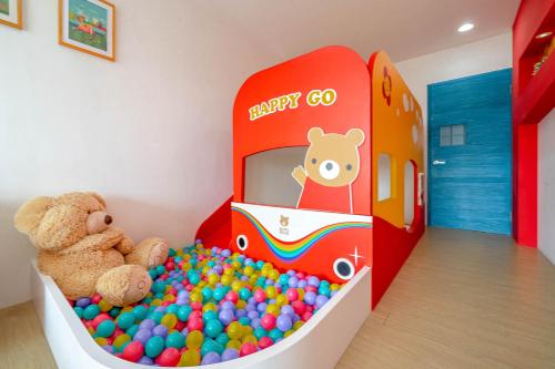 a childs room with a toy train and balls at Playful Paradise in Dongshan