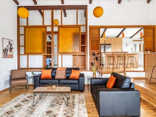 a living room with two couches and a table at Cloud Nine Gerringong in Gerringong