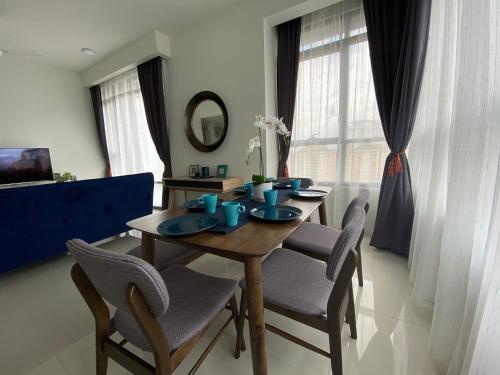 a dining room with a wooden table and chairs at KL East The Ridge in Kuala Lumpur