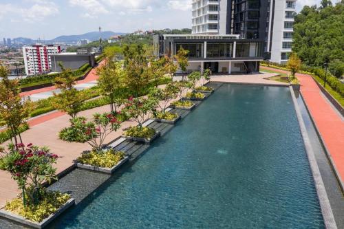 an overhead view of a pool with trees and buildings at KL East The Ridge in Kuala Lumpur