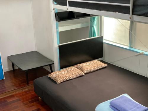 a bedroom with a bunk bed and a desk at Ishigakijima Guesthouse Seacoro in Ishigaki Island
