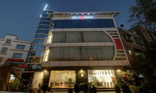 a building with a sign on the front of it at Treebo Glassotel Near Ruby Hospital in Kolkata