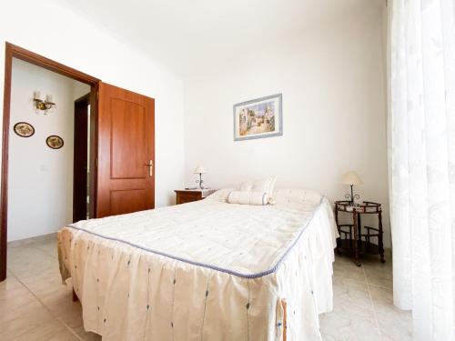 a bedroom with a large bed in a white room at Retreat with Terrace and View in Espiche #1887 in Espiche