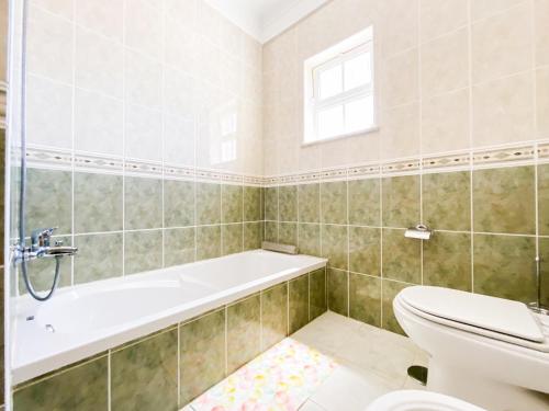 a bathroom with a toilet and a bath tub at Retreat with Terrace and View in Espiche #1887 in Espiche