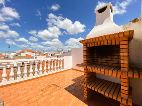 a brick fireplace on the roof of a house at Retreat with Terrace and View in Espiche #1887 in Espiche