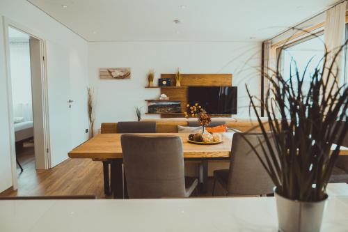 a dining room and living room with a table and chairs at Traunseeloft in Gmunden