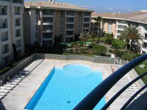 a view of a swimming pool from the balcony of a apartment at Résidence du Port - Borghese in Fréjus