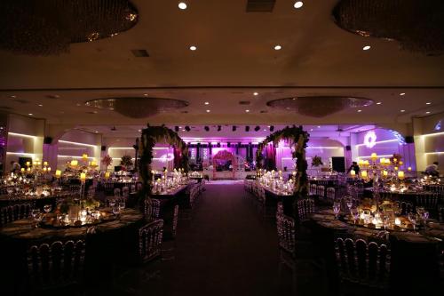 a banquet hall with tables and chairs and lights at Downtown Ankara Hotel in Ankara