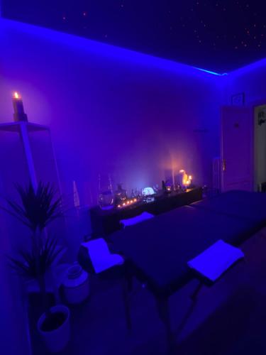 a blue room with tables and lights in it at Relais Stibbert Florence in Florence