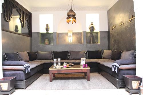 a living room with a couch and a table at Riad Terra Bahia in Marrakech