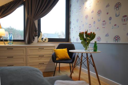 a room with a table and a chair and a window at LALA Kłączno małe SPA in Kłaczno