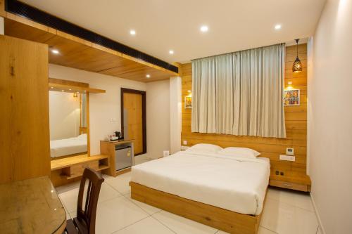 a bedroom with a bed and a large window at Hasco Tower in Palakkad