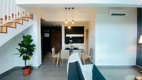 a dining room and kitchen with a table and chairs at Kuantan Imperium by Glex in Kuantan