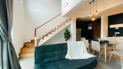 a living room with a green couch and a table at Kuantan Imperium by Glex in Kuantan
