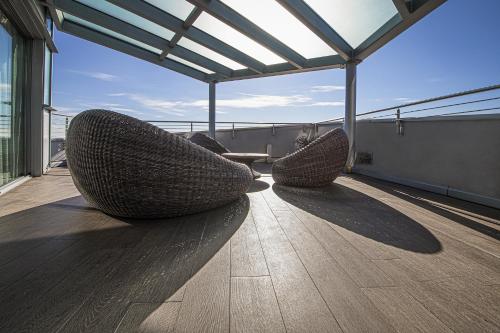 two wicker chairs sitting on top of a balcony at Hotel For You in Cernusco sul Naviglio