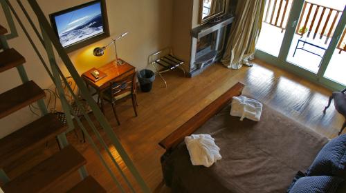 an overhead view of a living room with a television and a table at Aegli Arachova in Arachova