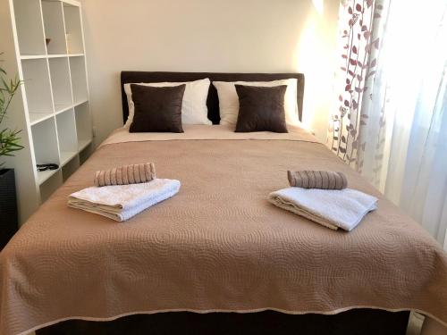 a bedroom with a large bed with two towels on it at Modern Studio (Institut Majka i Dete) in Belgrade