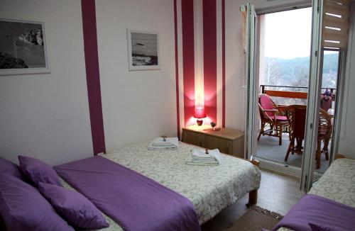 a bedroom with a bed and a table with a lamp at Biserna Dolina Uvac in Sjenica