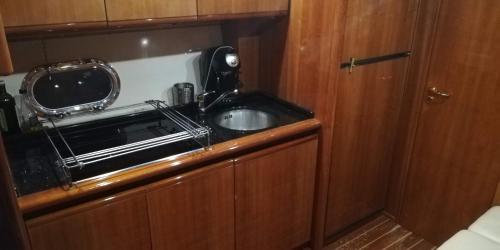 eine kleine Küche mit einem Waschbecken und einem Spiegel in der Unterkunft Gianetti 50' HT in Sorrent