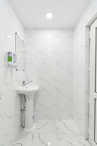 a white bathroom with a sink and a mirror at 7 days hotel in Almaty