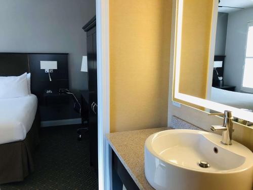 a bathroom with a sink and a bedroom with a bed at Best Western Plus Hawthorne Terrace Hotel in Chicago
