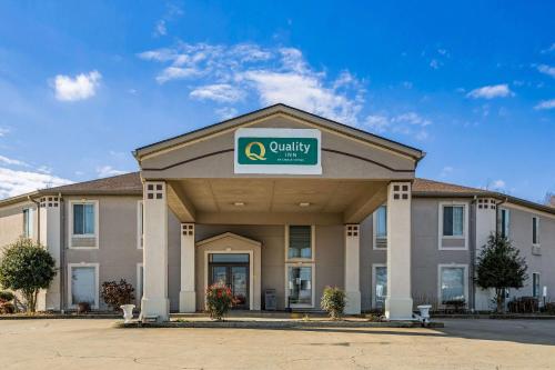 a hotel with a sign on the front of a building at Quality Inn Calvert City - Paducah East in Calvert City