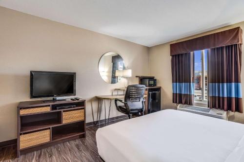 a hotel room with a bed and a television at Quality Inn Calvert City - Paducah East in Calvert City