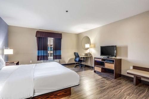 a hotel room with a bed and a flat screen tv at Quality Inn Calvert City - Paducah East in Calvert City