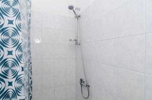 a bathroom with a shower with a shower curtain at Apartments Ammos in Saplunara