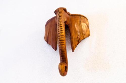 a wooden bird shaped object on a wall at Apartments Ammos in Saplunara