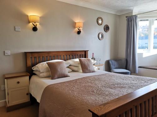 a bedroom with a large bed and a window at The River Haven Hotel in Rye