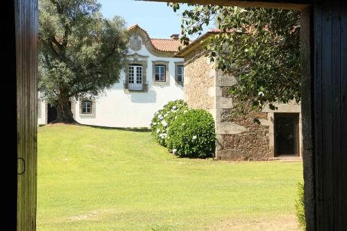 a view of a house through a door at Terra Rosa Country House & Vineyards in Ponte de Lima