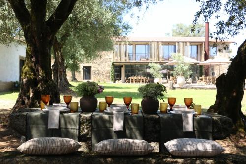 a table set up for a party in a garden at Terra Rosa Country House & Vineyards in Ponte de Lima
