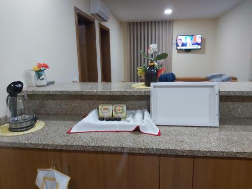 a kitchen counter with a towel and a sign on it at Casa da Tia Bina in Castelo de Paiva