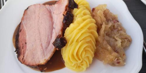 a plate of food with meat and potatoes on it at Hotel Filla Andre in Ernst