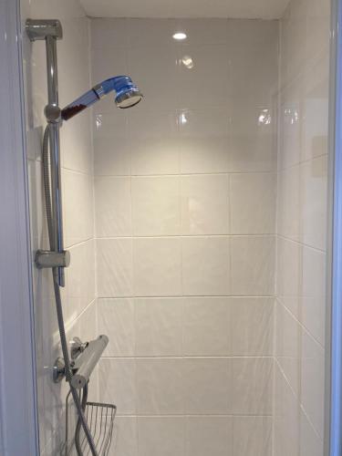 a bathroom with a shower with a shower head at The Old Brasserie & Rooms @ no.8 in Dartmouth