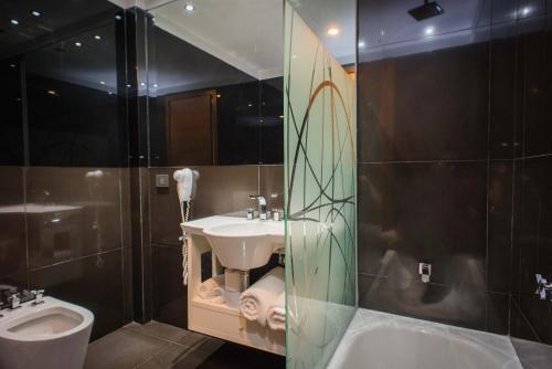 a bathroom with a sink and a toilet at Soho Luxury Suites in Buenos Aires