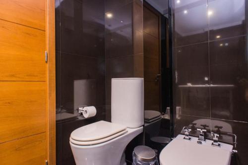 a bathroom with a toilet and a sink at Soho Luxury Suites in Buenos Aires