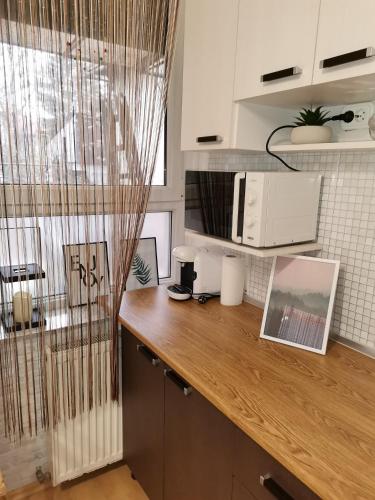 a kitchen with a wooden counter top with a microwave at Garden in Satu Mare