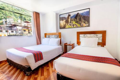 Un pat sau paturi într-o cameră la Hotel Machupicchu Inn