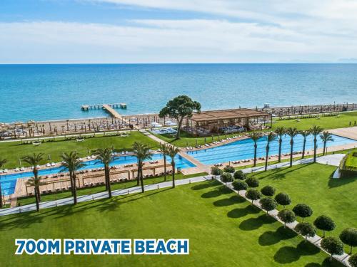 an aerial view of a resort with a swimming pool and the ocean at Rixos Premium Belek - The Land of Legends Access in Belek