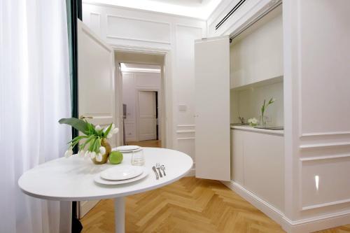 ローマにあるDomna Luxury Suitesのキッチンのある白い部屋にある白いテーブル