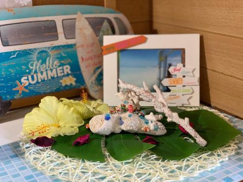 a toy train on a plate with a picture of a boat at Ishigakijima Guesthouse Seacoro in Ishigaki Island