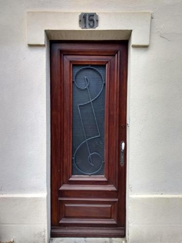 a wooden door with a sign on top of it at Number15 Guesthouse Carcassonne in Carcassonne