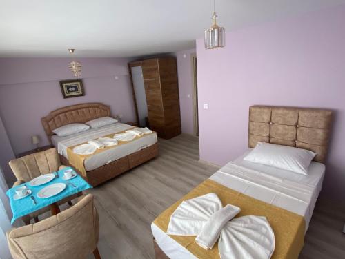 a hotel room with two beds and a table at Garden House in Istanbul