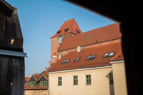 a large building with a clock tower on top of it at Gold Garden by Rentoom in Toruń
