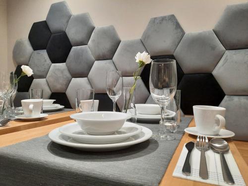 a table with plates and wine glasses on top at Rezydencja Biały Dworek in Wisła