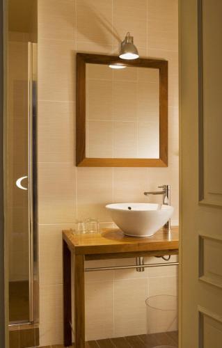 a bathroom with a sink and a mirror at Hotel De France in Angerville