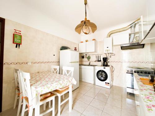 a kitchen with a table and chairs in a room at Simple Beach Lovers' Retreat in Espiche #1888 in Espiche